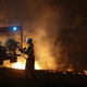 A firefighter works to extinguish flames after a bushfire burnt through the area in Bredbo, New South Wales, Australia earlier this month.